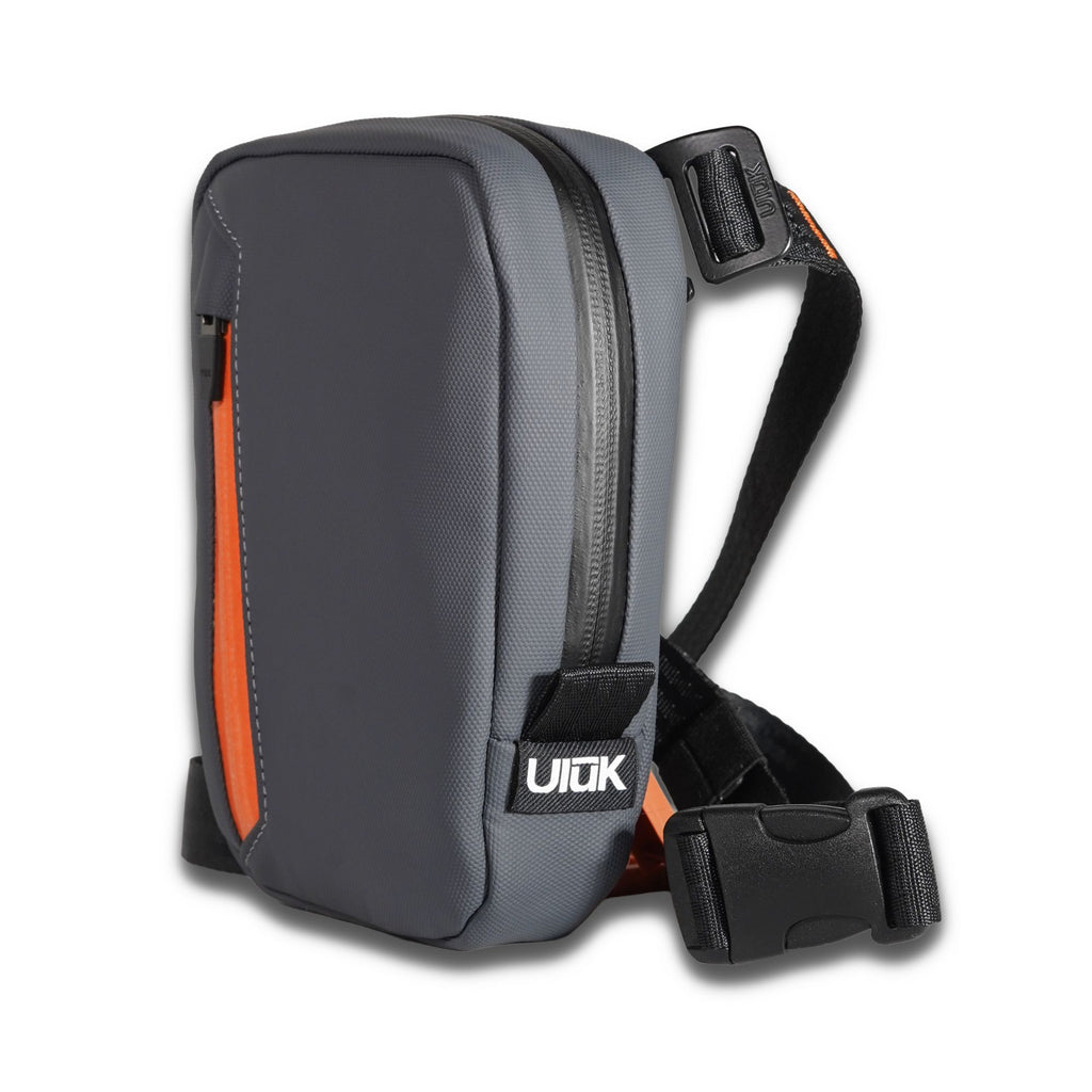 Angled view of the slate gray microsling showing its black strap and buckle.