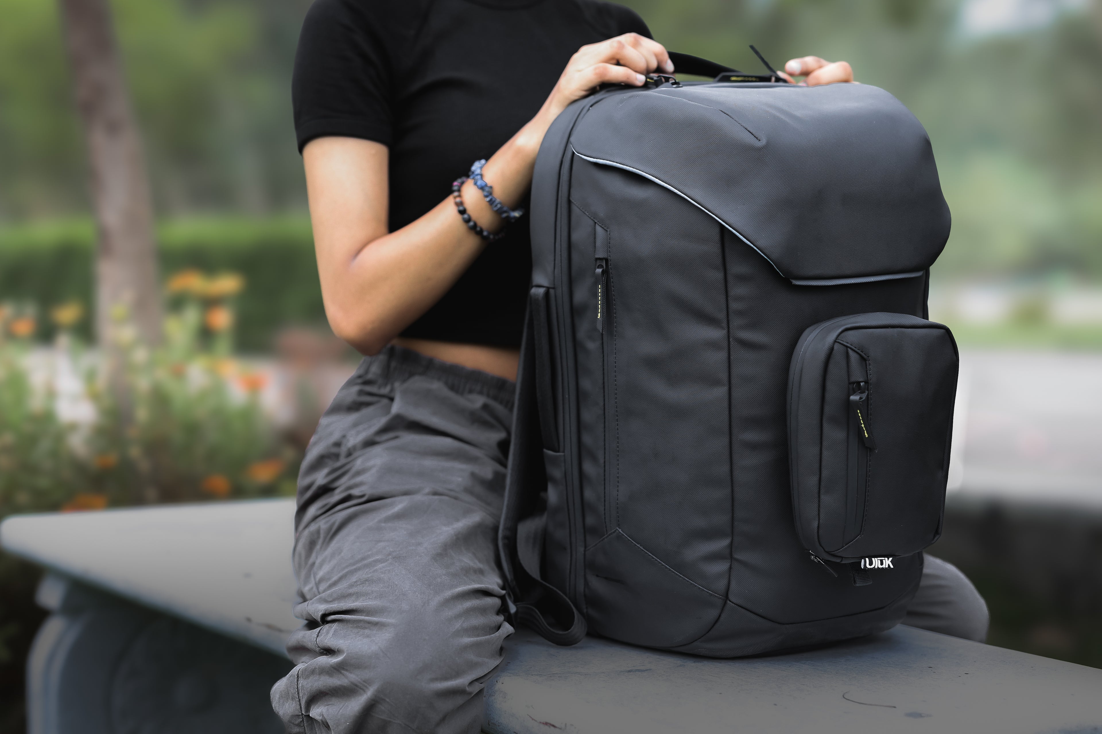 User holding EDC .28 TPU Onyx Black Backpack by Uluk Outdoors 