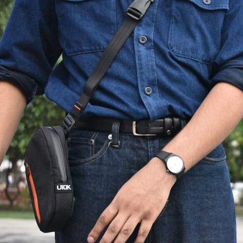 Person carrying EDC .X Microsling TPU Slate by Uluk Outdoors 